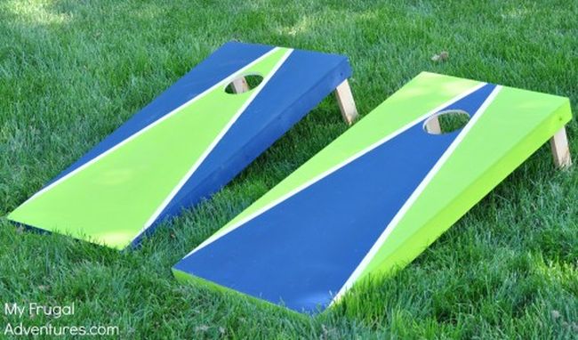 DIY cornhole boards painted blue and green, used for carnival games