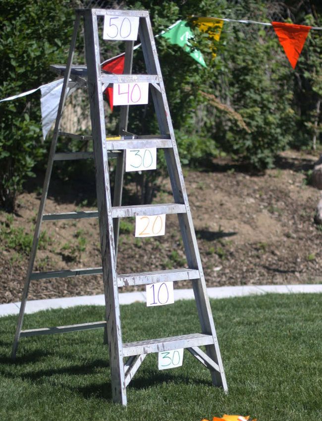 Ladder with each rung labeled with a different point value, used as a beanbag toss carnival game