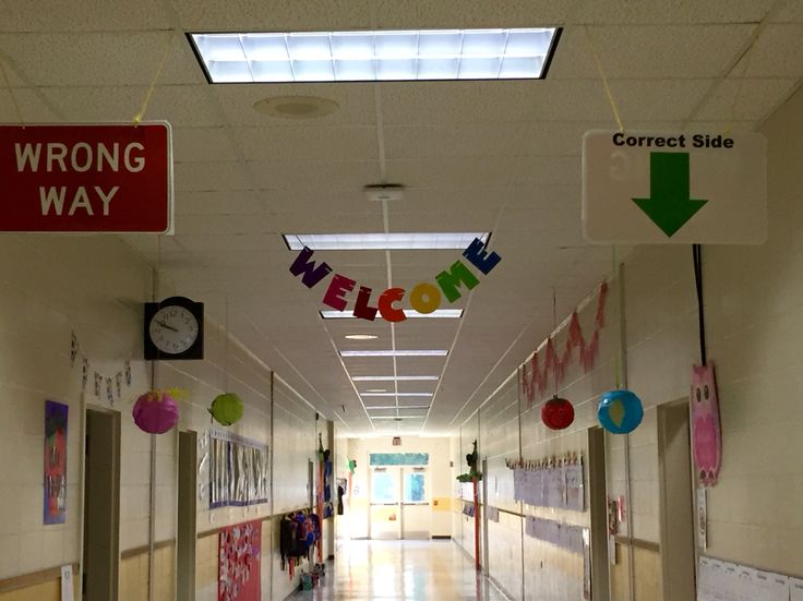 school hallway with signs indicating where students should walk 